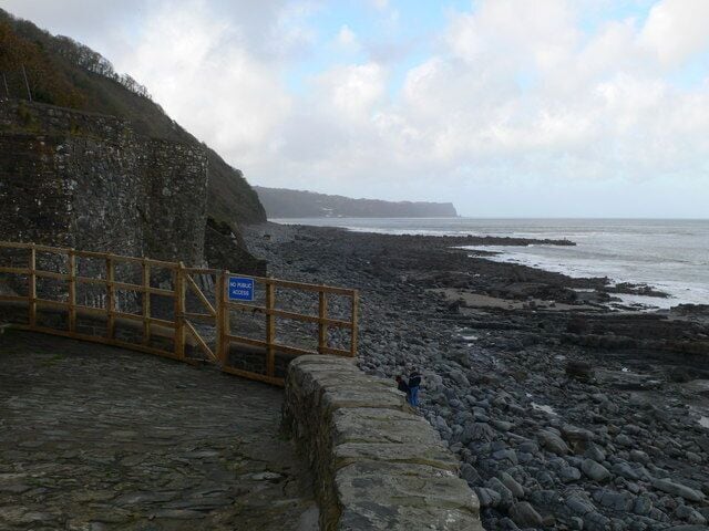 View westward at Buck's Mills beach The old quay juts out into the sea and beyond this, though not visible now, is "the Gore" - a pebble bank which runs out northwards into the sea
