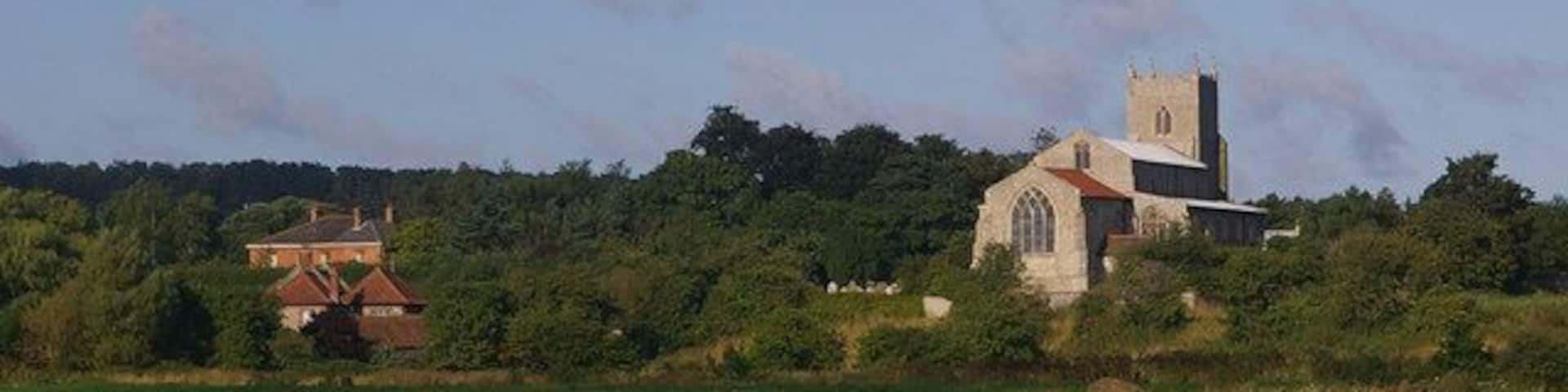 A church, a house, and a field.