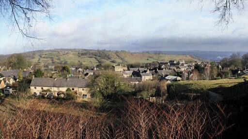 Winster is a well-preserved Derbyshire village west of Matlock. The vantage point of this composite photo is The Flat at the top of the lower branch of East Bank. It's just southwest of the Old Lead Mines near the centre of this 1899 map. Until the Leacroft Road estate was built in the mid 20th century, Winster comprised the three roads shown in the 1899 map. The most important, Main Street, is in the north of the village and runs east/west. South of Main Street the land rises towards the high ground known as Winster Bank. Two roads that lead south from Main Street and towards the Bank are known as West Bank and East Bank. This shot looks north so West Bank is to the left and East Bank is to the right. About half way up the hill, East Bank divides into two with one branch leading southwest and ending up as The Flat – the point from which this photo was taken. The other branch initially leads southeast but soon swings right and continues in a westerly direction until it joins West Bank at the point marked as Winster Bank on the map. The places that I've identified in notes include the tower of St John the Baptist's Church, Birchover Wood, the Dower House, West Bank House, Winster Hall, the Burton Institute and the former Tallow Factory.