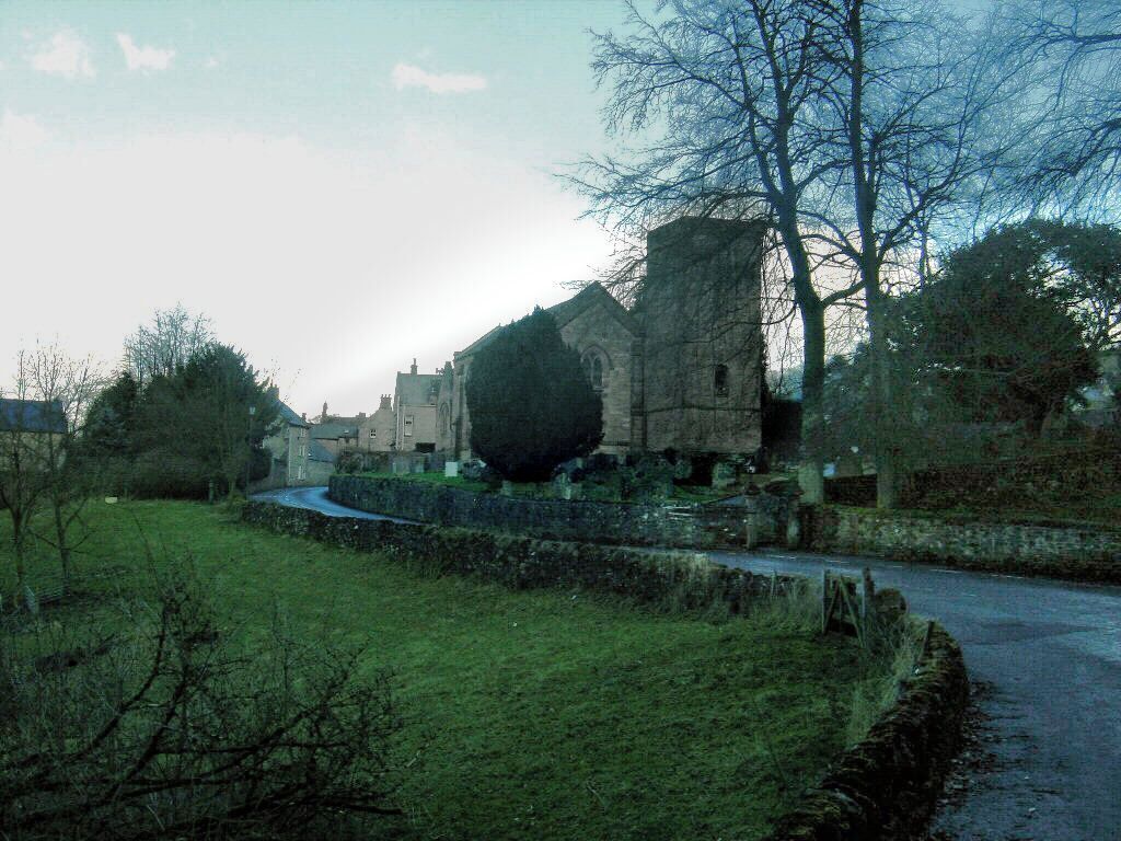 Winster is a Derbyshire village west of Matlock. Many of my ancestors were baptised, married or buried in the churchyard there. Their surnames include Wagstaff, Roose, Holmes, Mettam, Staley and Roberts. The Roberts family grave is not readily visible. It's beind the trunk of the tree in the centre of the photo. The shot was taken on a dull day in early April, 2006 and has been highly enhanced. There are better shots of the church elsewhere in my Winster set. Robert Cutts, son of Hilda Cutts née Roberts.