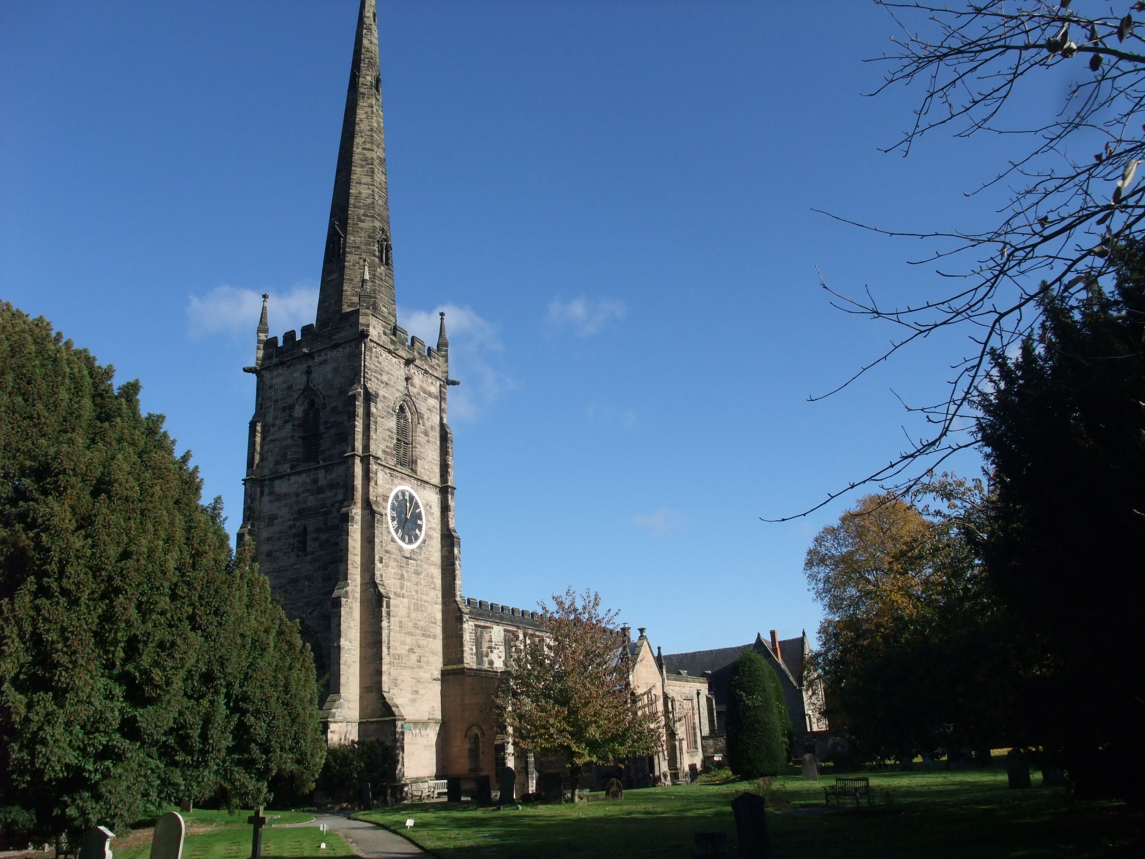 A church with a tall spire and a clock tower.