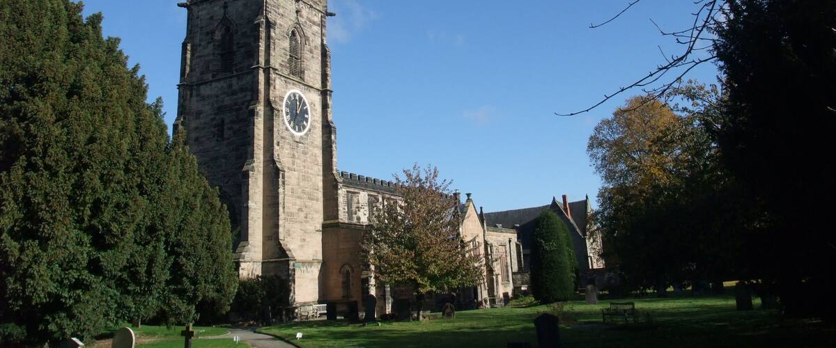 A church with a tall spire and a clock tower.