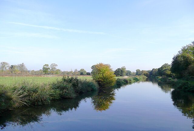 Trent and Mersey Canal near Findern, Derbyshire The canal takes a fairly straight course here through the flat farm lands on the Trent Valley bottom east of the Buckford bridges. The railway line between Stoke (or Burton) and Derby runs to the right of the picture less than thirty metres behind the trees.