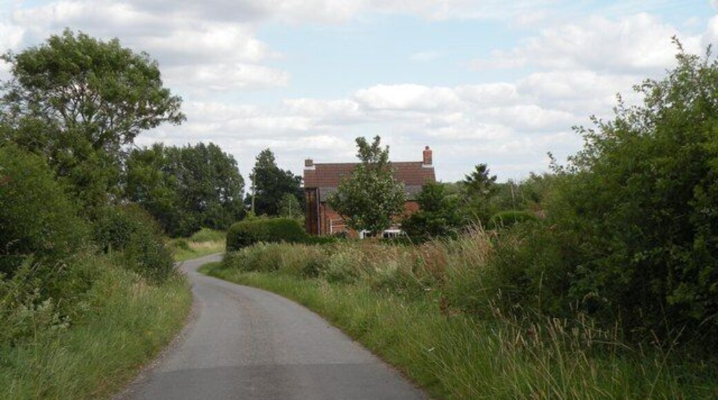 The northwest approach to Farley Green The building is Golden Farm.