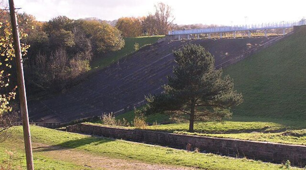 Toddbrook Reservoir: the dam. From Reservoir Road looking SSW. Toddbrook Reservoir was built in 1831 to store water for the nearby Peak Forest Canal.