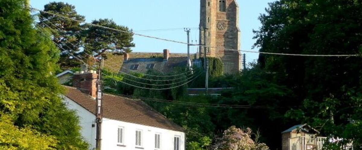 View south across the main street at Weston-under-Penyard, Herefordshire, toward the red sandstone tower of St Lawrence's parish church