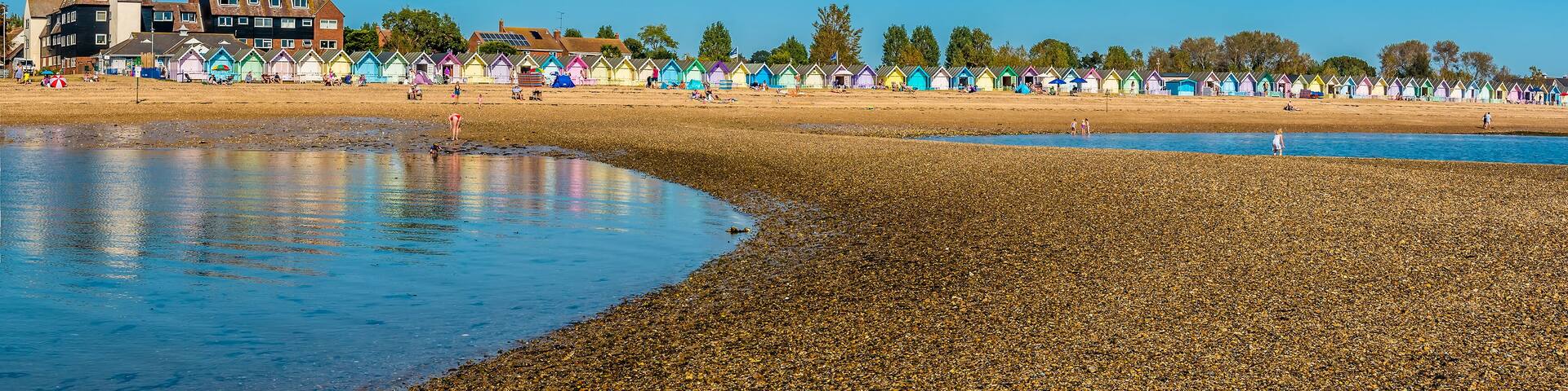 A wide-angle view from a sand bar towards the beach at West Mersea, UK in the summertime