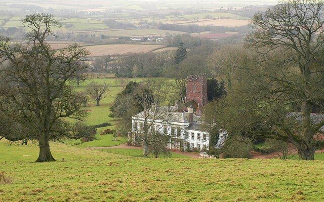 Bagborough House The house dates from about 1730, and was enlarged in the 1820s when the entrance was moved from the south side to this east side. Details at http://webapp1.somerset.gov.uk/her/details.asp?prn=40330 . Behind it is the C15 St. Pancras church, described at http://webapp1.somerset.gov.uk/her/details.asp?prn=40323 . Apart from the tower, "over-restored", says Pevsner (1958). Together they sit in an impressive landscaped park on the slopes of the Quantock Hills. Seen from Stout Lane.