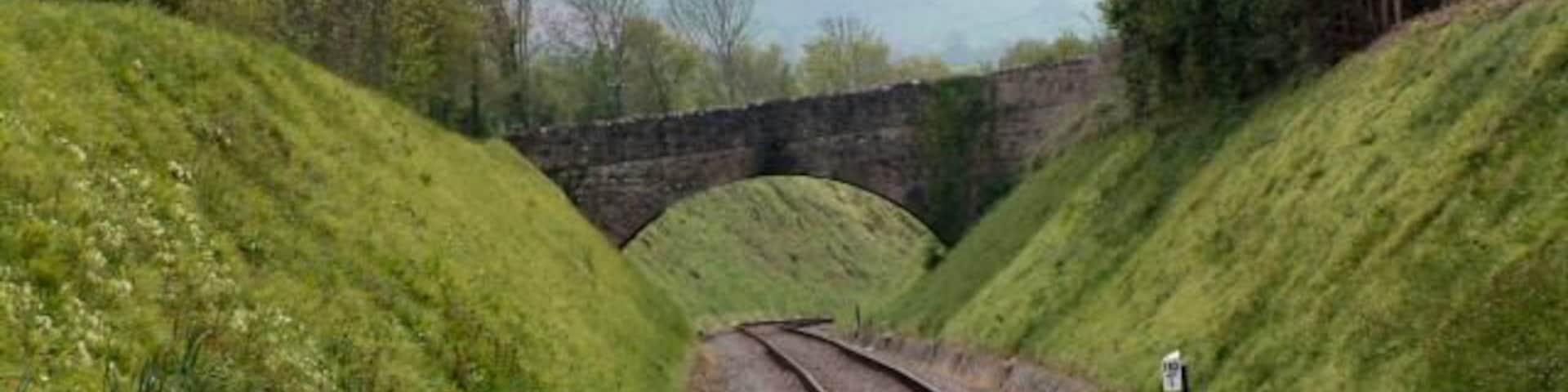 Bridge over West Somerset Railway near Halscombe House. The West Somerset Railway dives headlong into a deep cutting and onward to sea level at Blue Anchor...