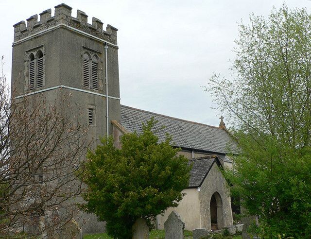 Trusham Church viewed from the churchyard next to the village hall. The church of St. Michael, erected in 1259 and the aisle added in 1430, is an ancient building of stone in the Early English and Perpendicular styles with traces of Norman work. . . . the church was thoroughly restored in 1865.