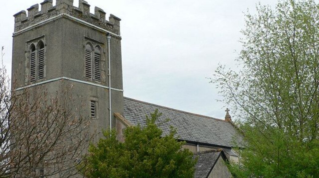 Trusham Church viewed from the churchyard next to the village hall. The church of St. Michael, erected in 1259 and the aisle added in 1430, is an ancient building of stone in the Early English and Perpendicular styles with traces of Norman work. . . . the church was thoroughly restored in 1865.