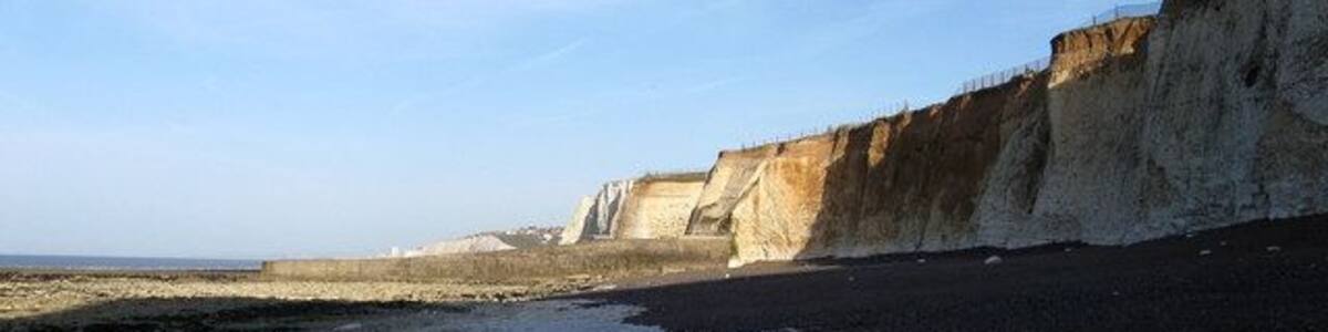 Beach near Portobello Pumping Station Given some protection by the defences protecting the pumping station a small shingle beach has formed between the cliffs and the rocky foreshore. However, access is very limited by foot around the base of the groyne in the distance meaning a secure knowledge of the tide times is imperative if visiting otherwise there is the very real danger of being isolated and cut off.