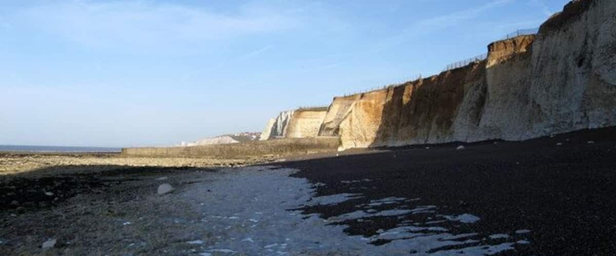 Beach near Portobello Pumping Station Given some protection by the defences protecting the pumping station a small shingle beach has formed between the cliffs and the rocky foreshore. However, access is very limited by foot around the base of the groyne in the distance meaning a secure knowledge of the tide times is imperative if visiting otherwise there is the very real danger of being isolated and cut off.