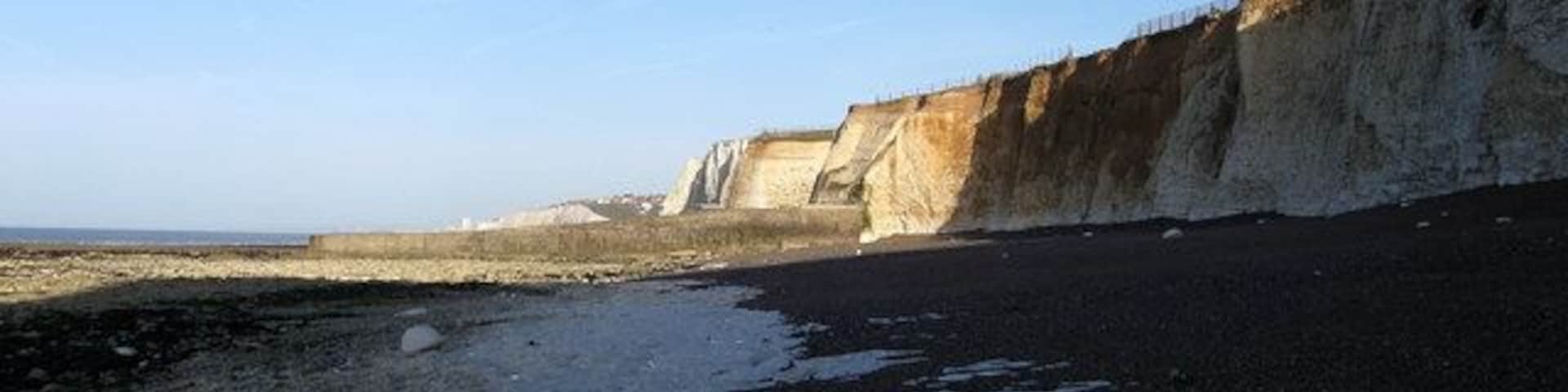 Beach near Portobello Pumping Station Given some protection by the defences protecting the pumping station a small shingle beach has formed between the cliffs and the rocky foreshore. However, access is very limited by foot around the base of the groyne in the distance meaning a secure knowledge of the tide times is imperative if visiting otherwise there is the very real danger of being isolated and cut off.