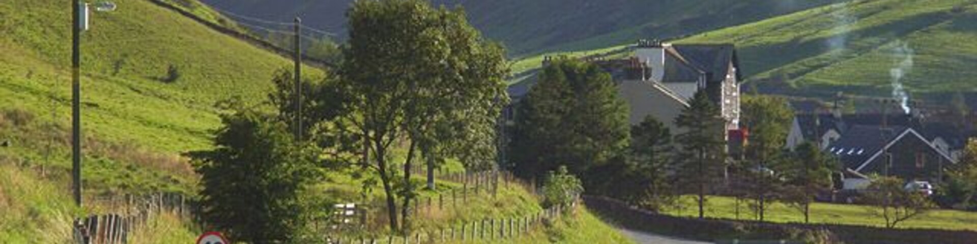 The A685, Tebay The road leaving the main part of the village as it makes its way towards Kendal. The buildings ahead are just above the site of the former railway station. The former Junction Hotel is prominent. The narrow valley is that of the River Lune. It separates the Howgill Fells to the left from the foothills of the Lake District to the right. As well as the road, the M6 and the West Coast Mainline run through this gap in the hills.