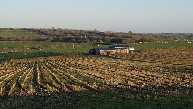 A rural landscape with a barn and fields.