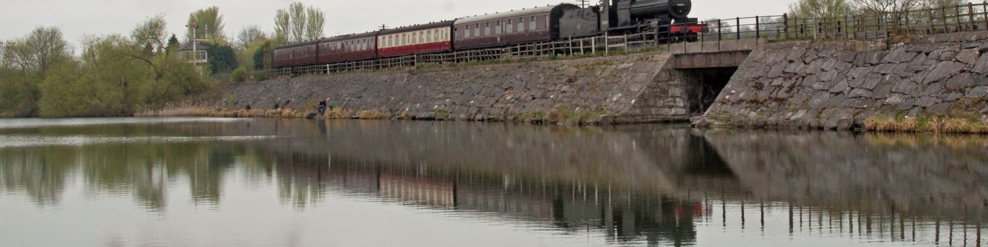 Preserved steam locomotive S&DJR 7F 2-8-0 No. 53809 crossing Butterley Reservior at the Midland Railway - Butterley heritage railway.