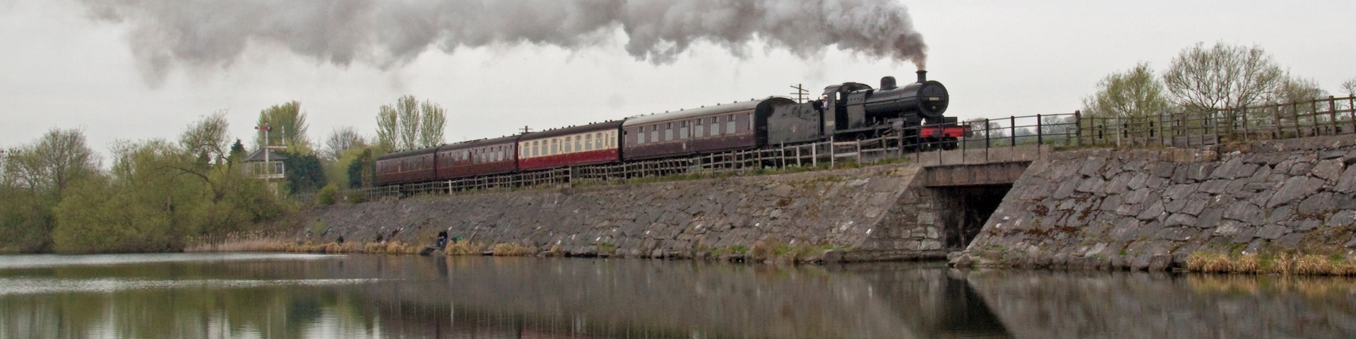 Preserved steam locomotive S&DJR 7F 2-8-0 No. 53809 crossing Butterley Reservior at the Midland Railway - Butterley heritage railway.
