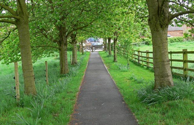 Path from the church Looking from the churchyard of Saint James Church towards the Main Street of Sutton Cheney.