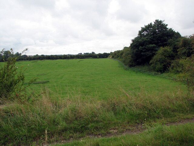 Colsterworth: former ironstone quarry The field - once Colsterworth No 1 Quarry - is below Old Post Lane (behind the trees on the right) and the footpath from which the photograph was taken. This was a much shallower quarry than the later ones at Colsterworth and Woolsthorpe. See other photos nearby for more on the quarries and railways in the area.