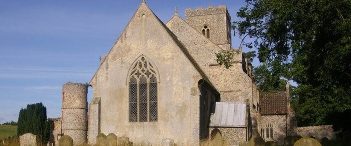 Church of St John the Baptist, Stiffkey Grade I listed church mainly dating from the late 13th/early 14th century, but with parts restored in 1848. The round tower on the left is in the grounds of the 16th century Stiffkey Hall.