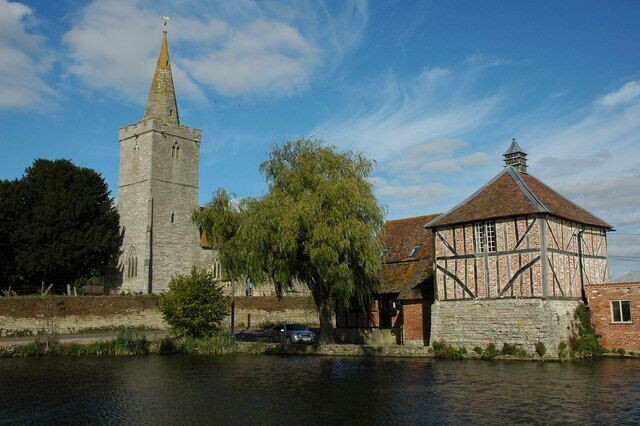 A historic tower, a Tudor-style building, and a river.