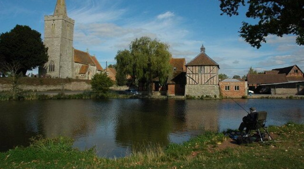 Staunton Church and duck pond A picturesque scene with a man sat fishing in a duck pond in front St James's church and Staunton Court.
