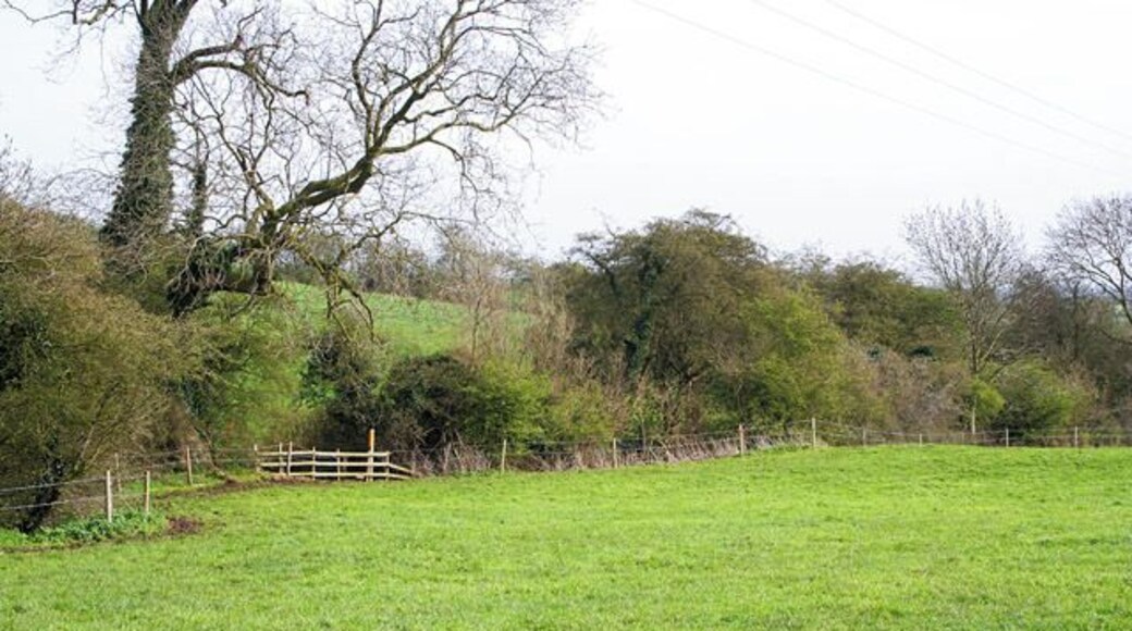 Farmland between Eastwell and Eaton The footpath marker can be seen by the hedgerow that follows a small brook, the River Devon that feeds into Knipton Reservoir and eventually flows into the River Trent.
