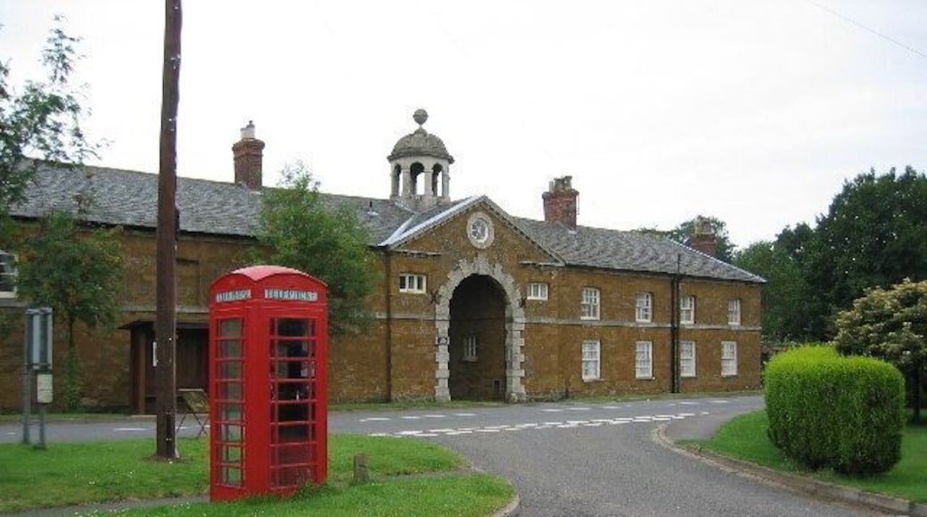 Eastwell village centre, Leicestershire. The old coach house and stables of Eastwell Hall have been converted into two houses, one either side of the coach arch.