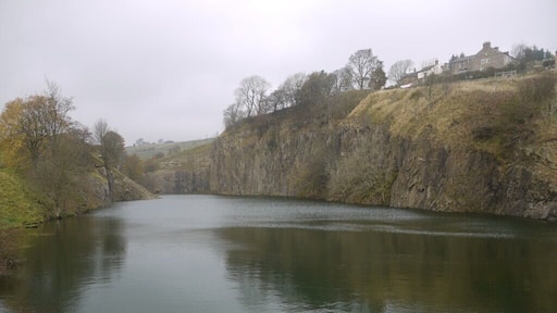 Copthill Quarry Disused and flooded quarry on the outcrop of the whin sill at Cowshill. The quarry was opened up in 1895 by Octavius Monkhouse who was the Innkeeper at the nearby Cowshill Inn and son of the local minister. The quarry is one of two whinstone quarries in Weardale, the other is at Stanhope, and rock was carted from the quarry to Wearhead railway station and from there down the dale for use in construction projects. About 50 men worked the quarry in the early days and as it developed permission was obtained to demolish first the vicarage and then the church itself. Now only the graveyard remains, above the quarry, north west of Copthill Farm. By 1926 the quarry was in financial difficulties and closed down but a group of local men formed the Cowshill Quarry Company and this new company took over and continued the work up until final closure in 1943. http://www.aditnow.co.uk/mines/Copt-Hill-Whinstone-Quarry/