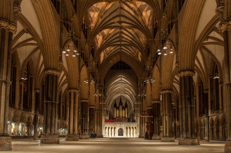 A cathedral interior with high vaulted ceilings and rows of columns.