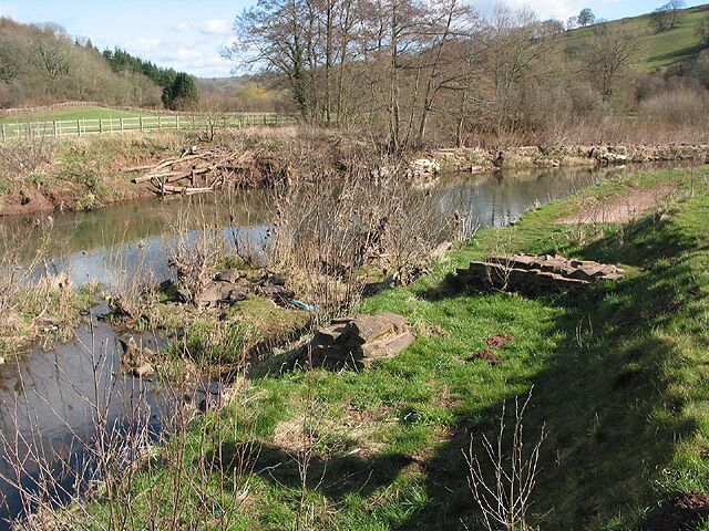 Site of medieval castle wharf by the River Monnow A medieval castle wharf was discovered here in 2003 and has been re-buried to protect it. A massive dockyard wall projected into the river. The wharf may have been in use during the building of the castle (1219-32).