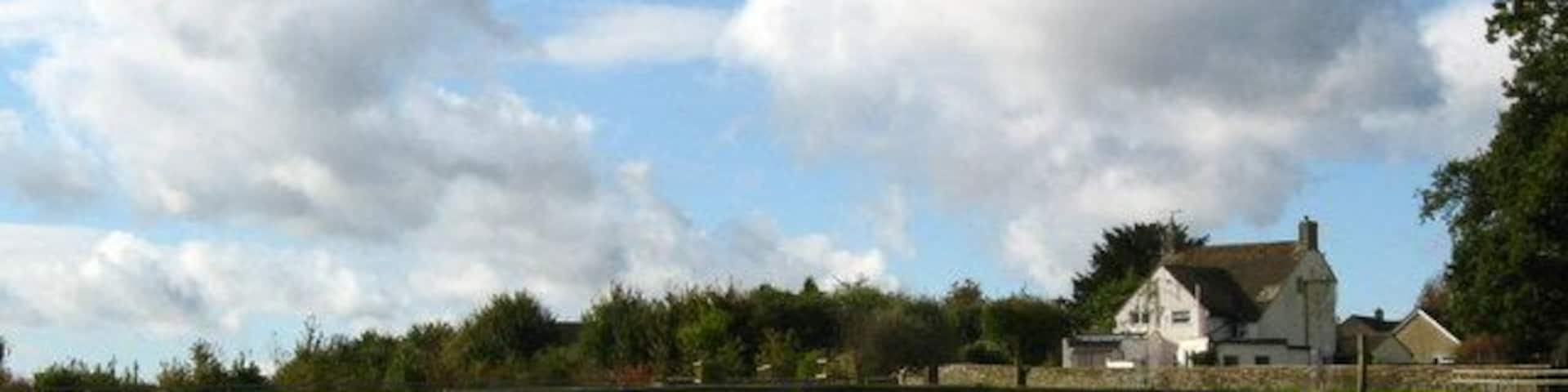 Horse jump and stile near Sherston On a footpath, looking back towards the village.