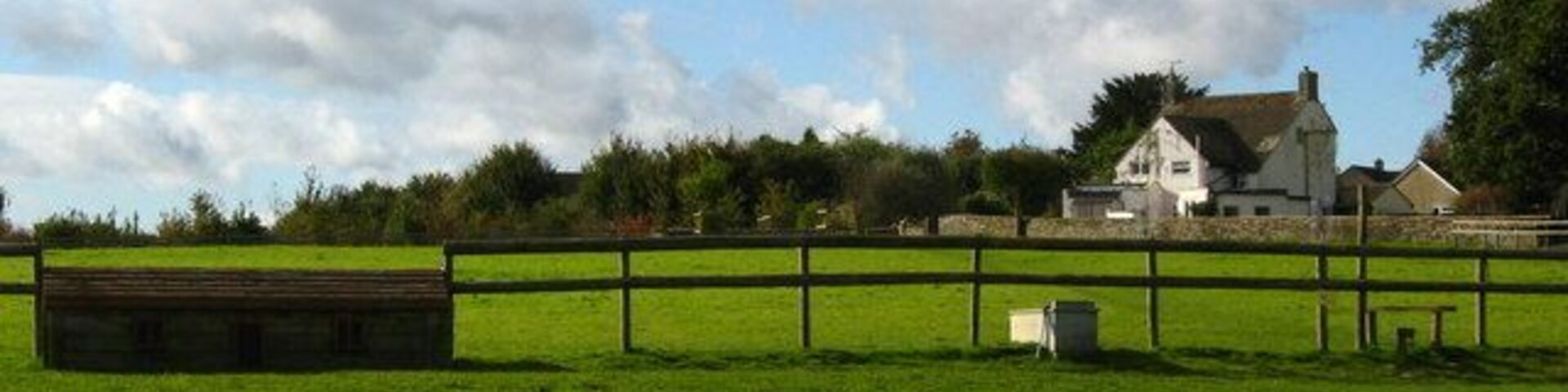 Horse jump and stile near Sherston On a footpath, looking back towards the village.