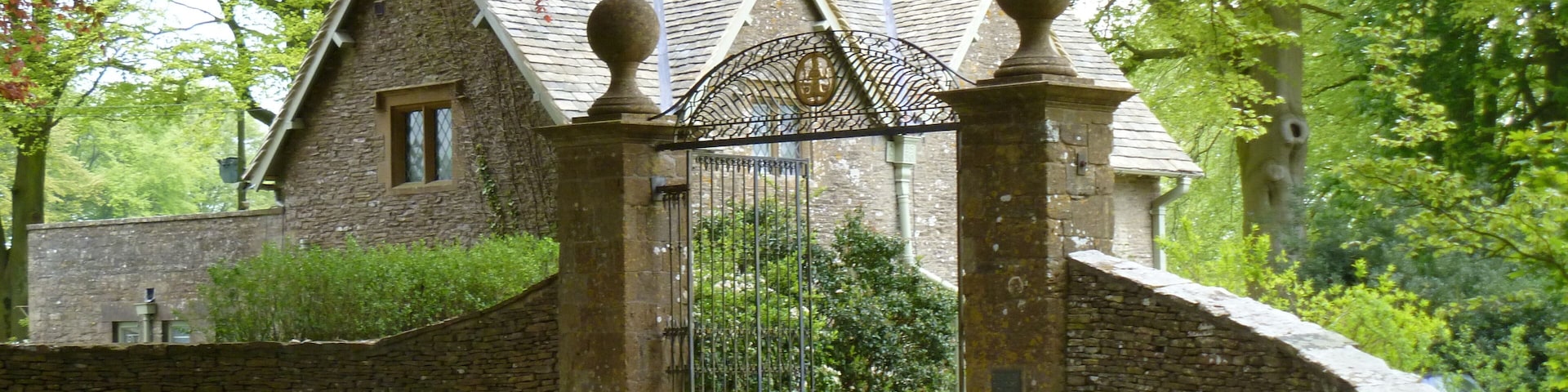 The Lodge. Seen from the minor road, The Lodge was once the gate lodge to Notgrove Manor. The Manor is in the Register of Historic Parks and Gardens for its special historic interest.