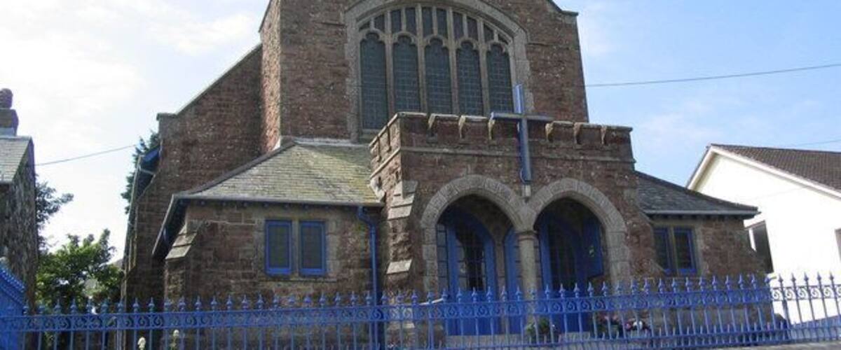 A historic church with a prominent arched entrance and a tall steeple.