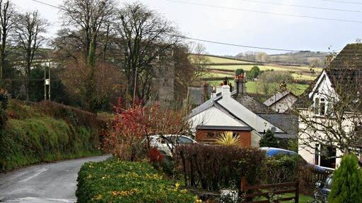 St Dominick Village Looking down the main village road towards the church in the adjacent grid square SX3967.