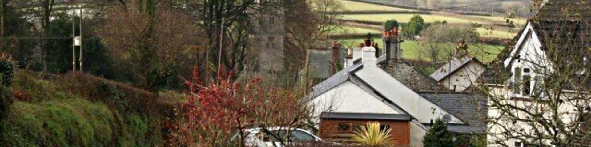 St Dominick Village Looking down the main village road towards the church in the adjacent grid square SX3967.