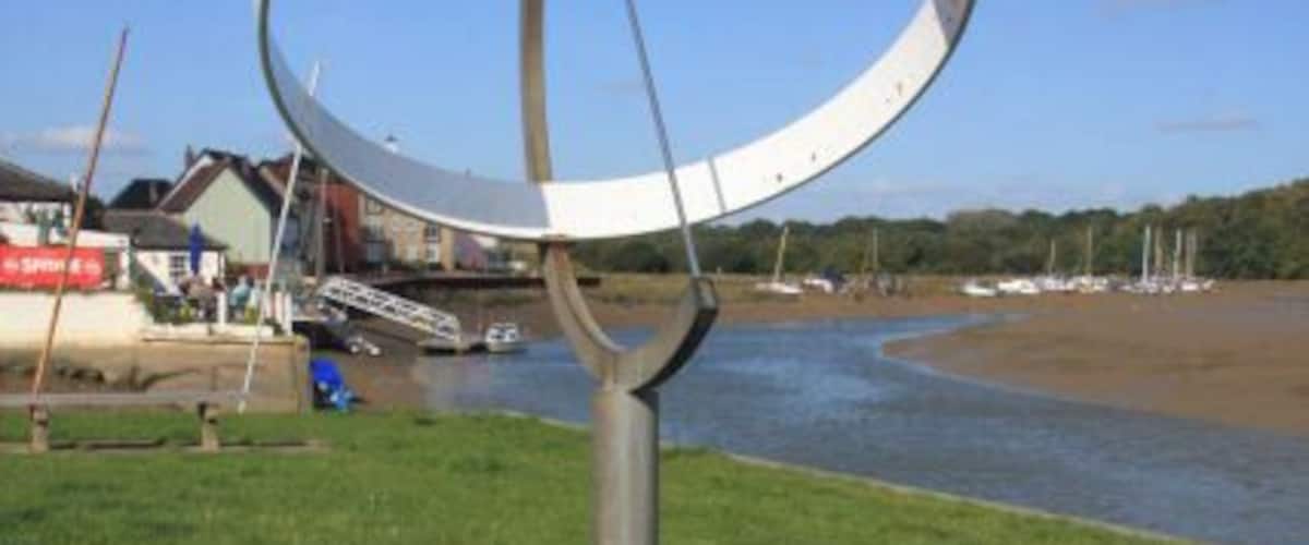 Equatorial sundial at Pearson's Quay, Rowhedge, Essex. This section of former quay was opened to the public on 11 September 1976. The sundial commemorates this opening, which was performed by Reg White, who had won a yachting gold medal at the Montreal Olympics earlier that year.