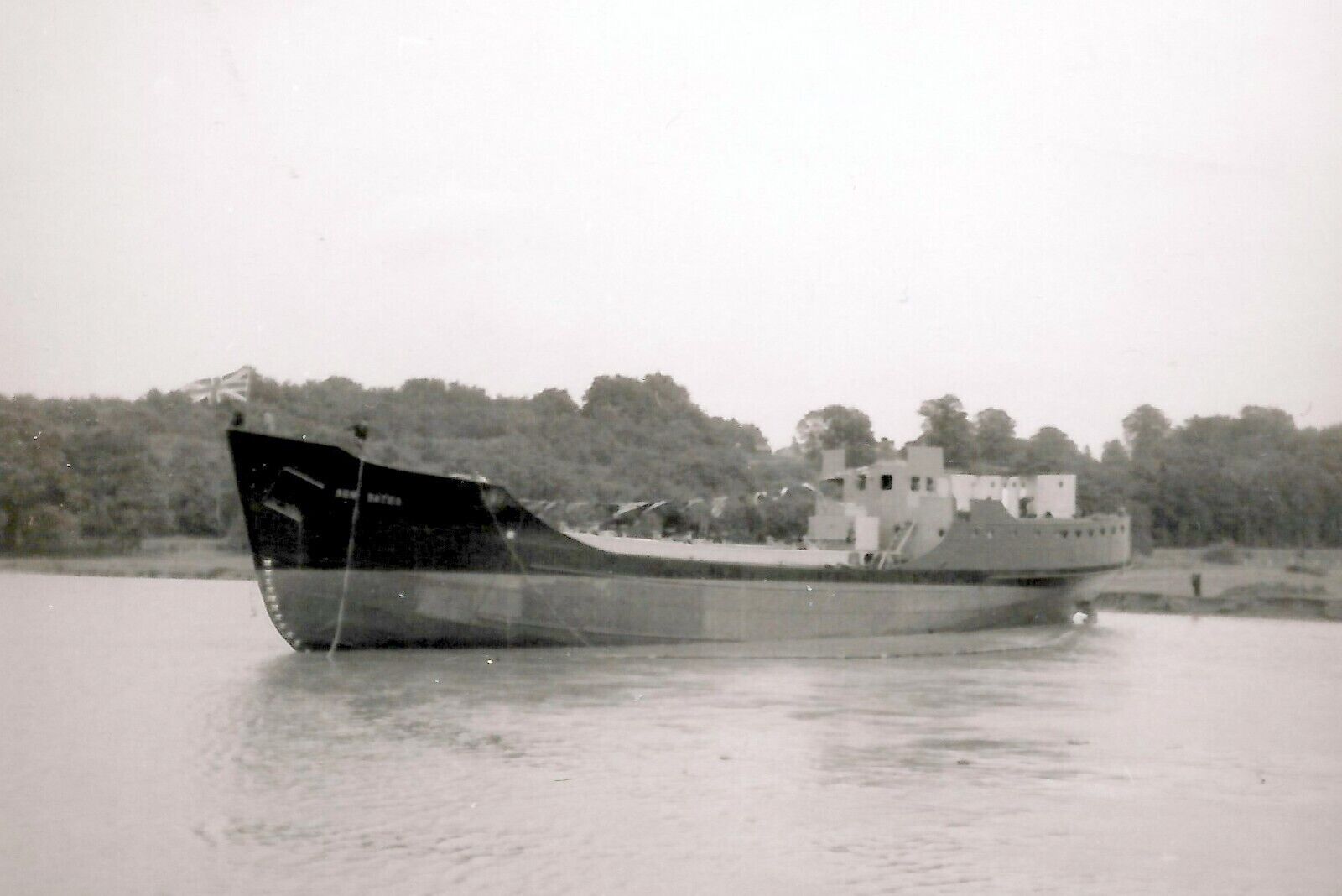 Ben Bates in the river. Having been launched the ship lays awaiting a tug. On the bow shipwrights are releasing the launch chocks.