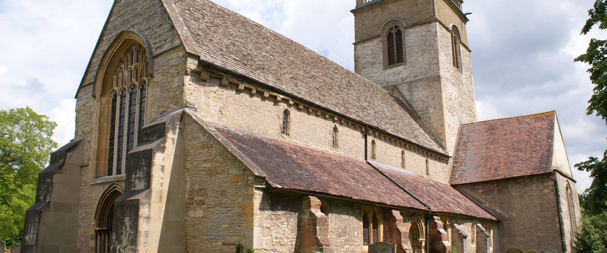A historic church with a prominent tower and arched windows.