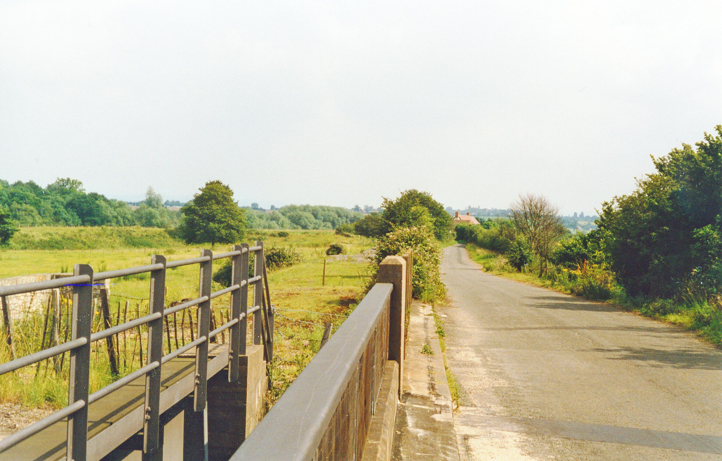 Bow Lane, Ripple, at bridge over M50 Motorway, 1997. View SE towards Twyning and Tewkesbury, parallel to right of the track-bed of the former ex-Midland Railway Ashchurch - Upton-on-Severn - Great Malvern branch, which was finally closed 1/7/63. The River Severn is over to the right.