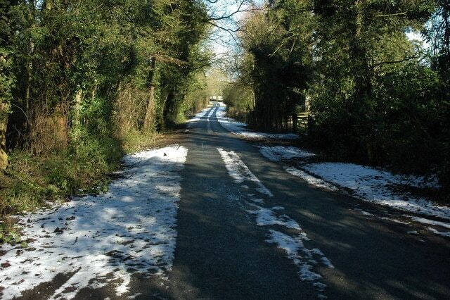 Down House Lane to Lowbands Down House Lane after a light snow fall.