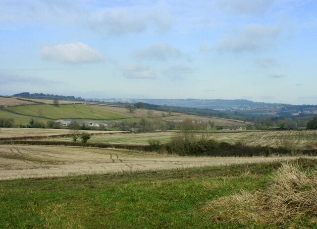 Fields west of Priston Conygre Brook runs along the valley in front of us, this is the stream which powers Priston Mill. Look at the skyline to the right of centre and you may see a tiny blip. This is Beckford's Tower ST7367 on Lansdown.
