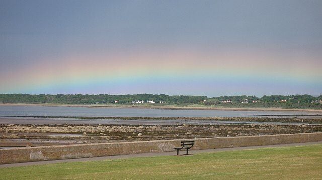A low rainbow, Seton Sands The Links, Seton Sands, with a bright rainbow band across the eastern horizon.