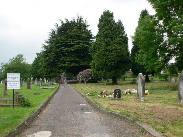 Churchyard - Holy Trinity Church Cwmbran The church is hidden among the trees at the end of the path.