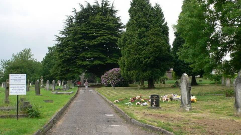 Churchyard - Holy Trinity Church Cwmbran The church is hidden among the trees at the end of the path.