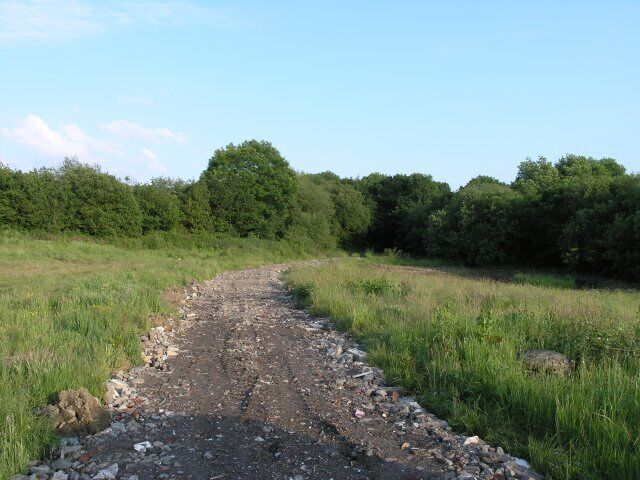 Rubble trackway through farmland Despite having a prominent footpath sign at the beginning of the track, this path had a number of locked gates along its route.