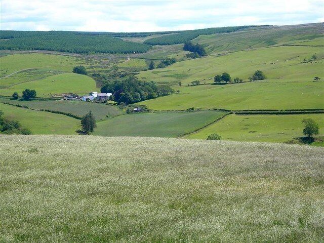 Towards Balligmorrie The farm in the background, in another square on the other side of the River Stinchar, is Balligmorrie. Viewed from the watershed between the Water of Assel and the Stinchar.