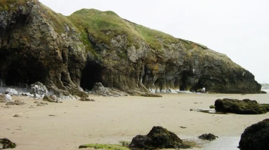 Cove west of Dolwen Point. There are several small caves in the cliffs here. The famous Pendine Sands are just around the headland.
